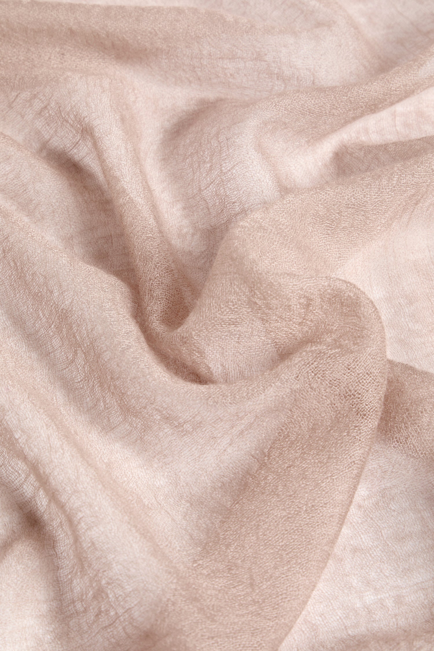 Close-up of crumpled beige fabric with a soft texture and visible creases, reminiscent of a Soft Weave Cashmere Scarf.