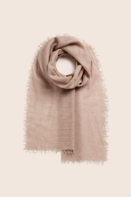 Soft Weave Cashmere Scarf in beige, featuring a raw-edge tassel finish and folded in a loop on a light background.