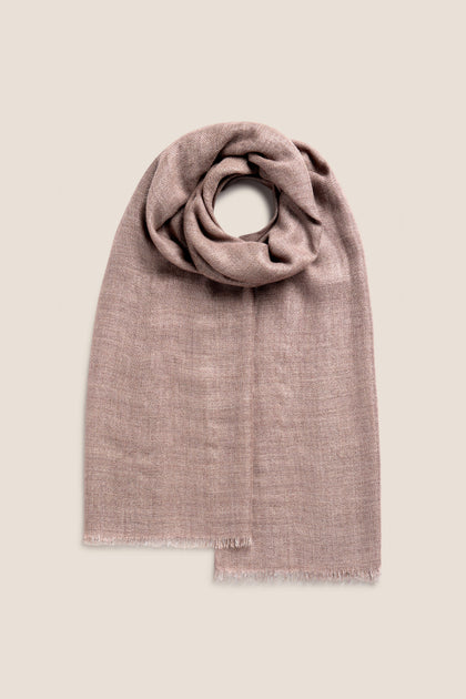 The Sparkle Scarf, a folded brown soft wool-mix accessory with a gentle texture, is displayed on a neutral background, showcasing its subtle sophistication.