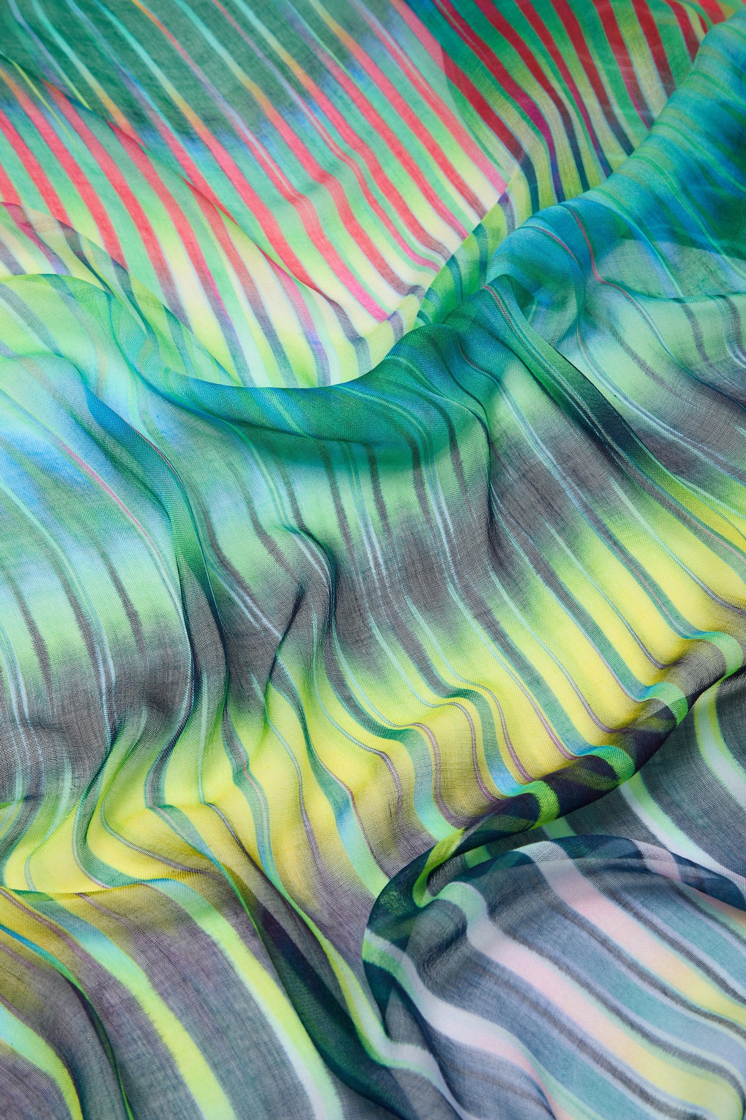 A close up of a vibrant Ikat Zig Zag Scarf with stripes.