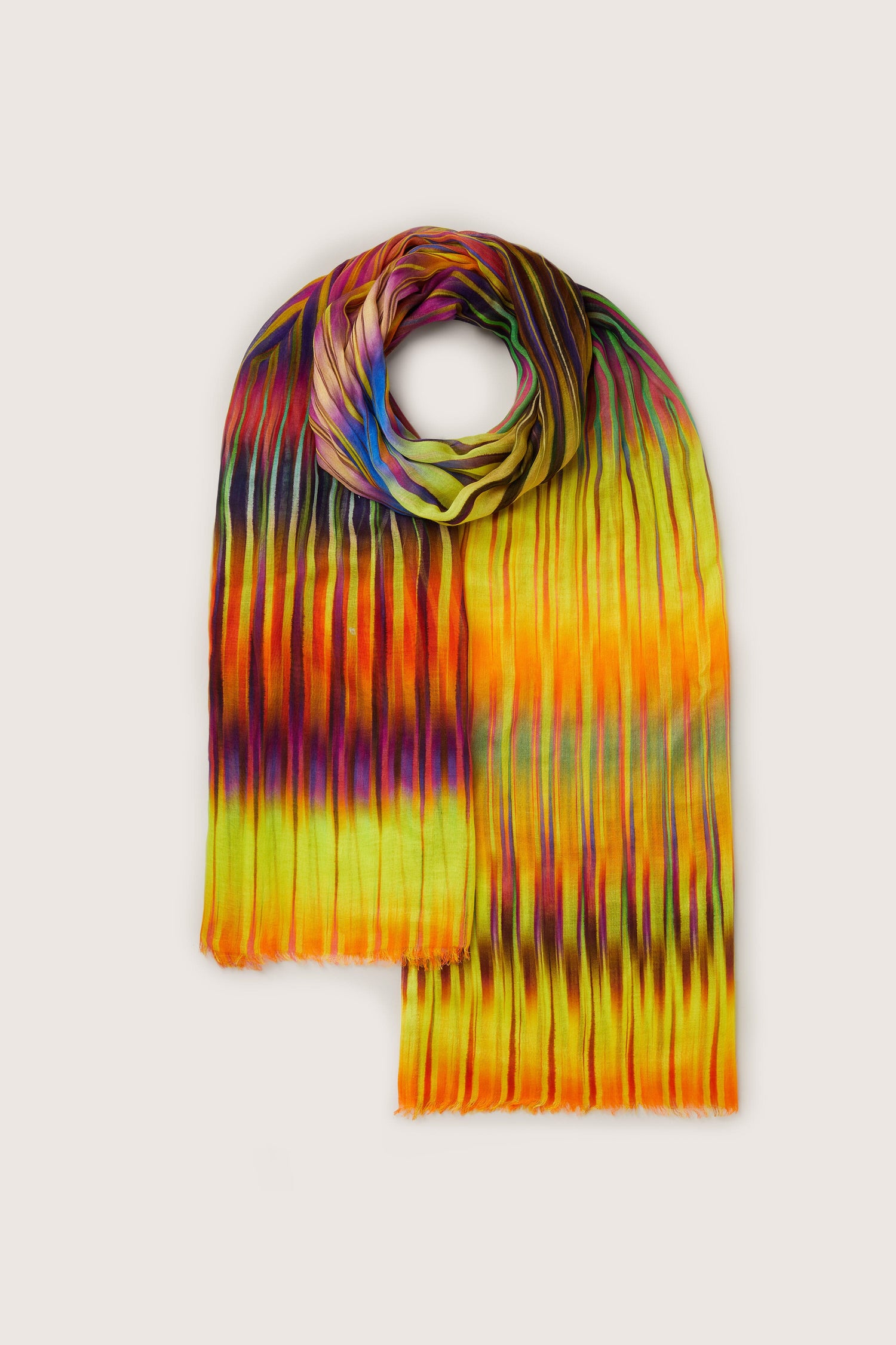 A whimsical, colorful Ikat Zig Zag scarf with an ikat-inspired rainbow pattern.