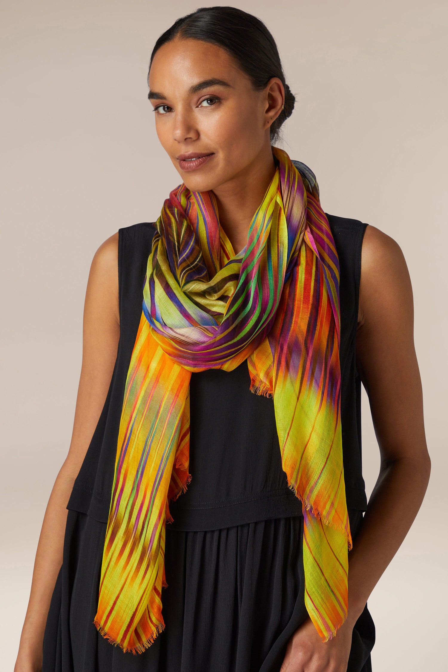 A woman wearing a colorful Ikat Zig Zag scarf.