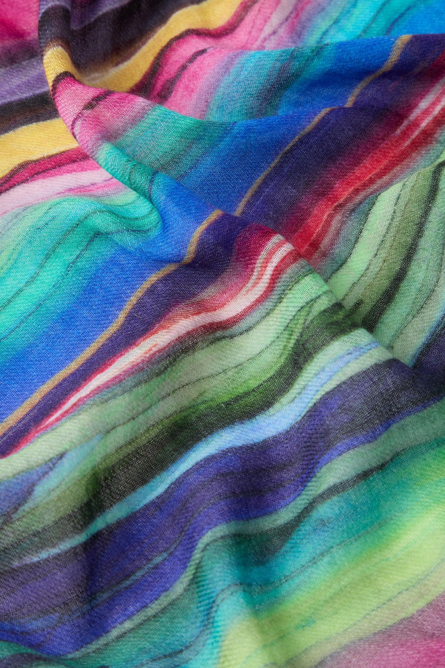 A close-up view of a vibrant, multi-striped fabric featuring wavy patterns in shades of blue, green, pink, yellow, and purple. Ideal for all-occasion styling, this Watercolour Landscape Wool Scarf is made from soft wool, offering a cozy yet lively accessory.