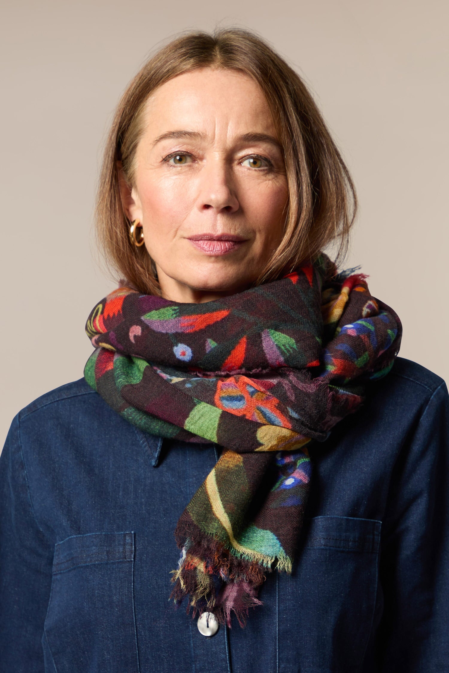 A woman in a blue shirt wearing a Floral Garden Scarf.