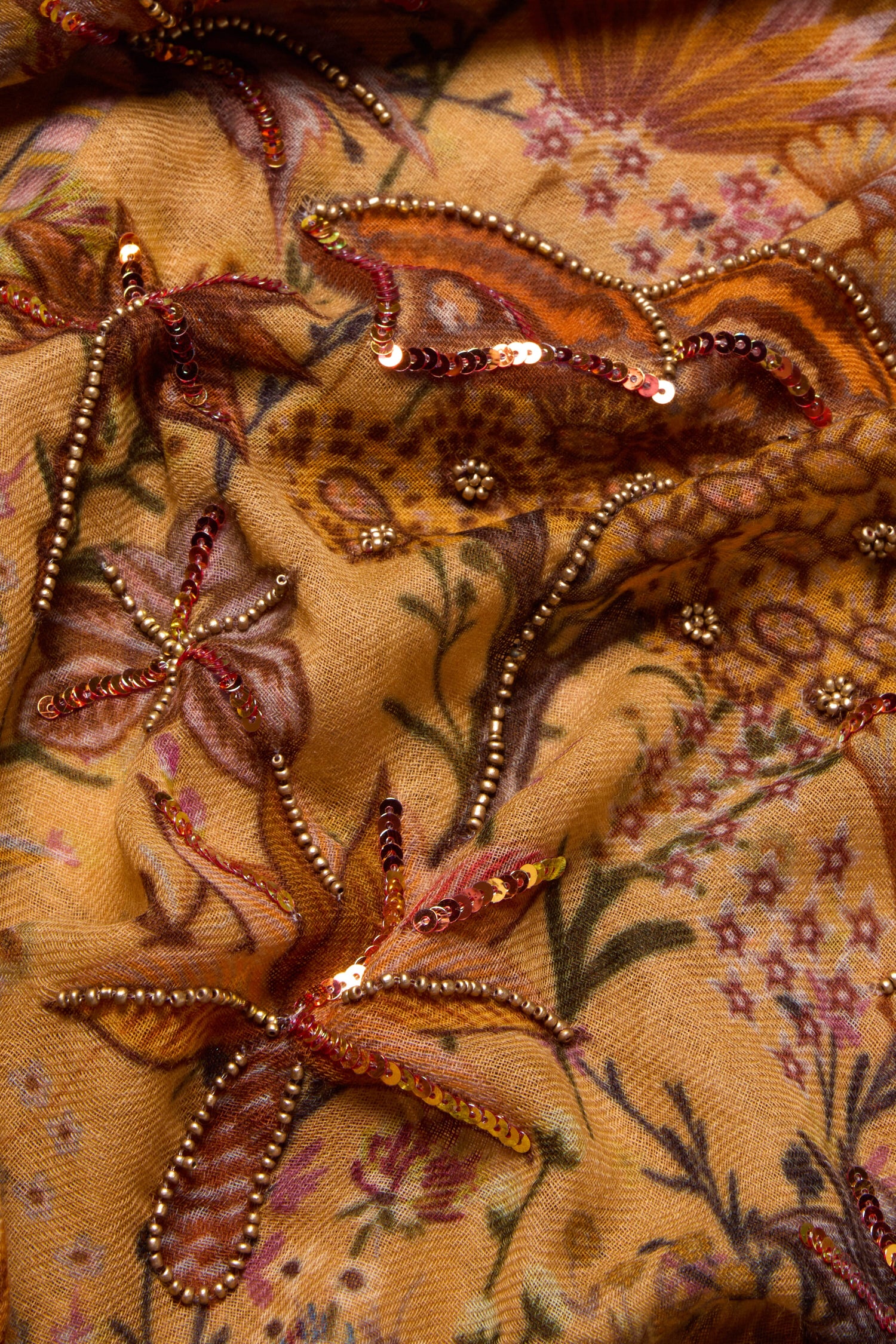 A close up of the Paradise Sequin Detail Wool Scarf with intricate beading on it.