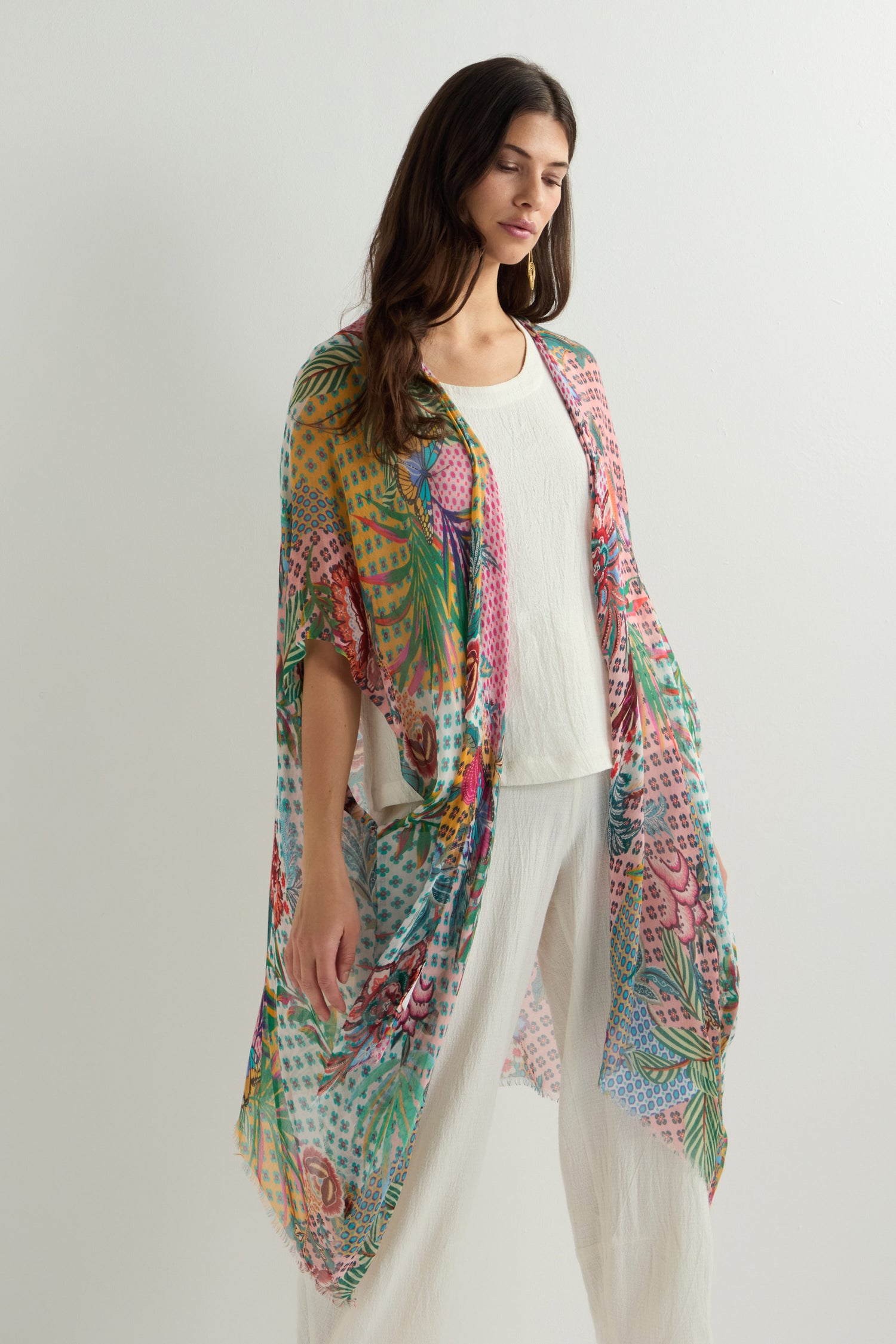 Someone wearing the Botanical Patchwork Kimono over a white outfit is set against a plain background.