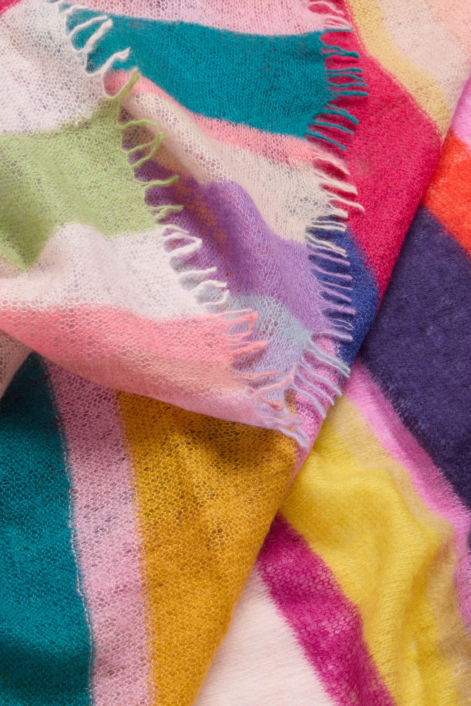 A Rainbow Stripe Cashmere Scarf, featuring a rainbow stripe pattern, placed on top of a white background.