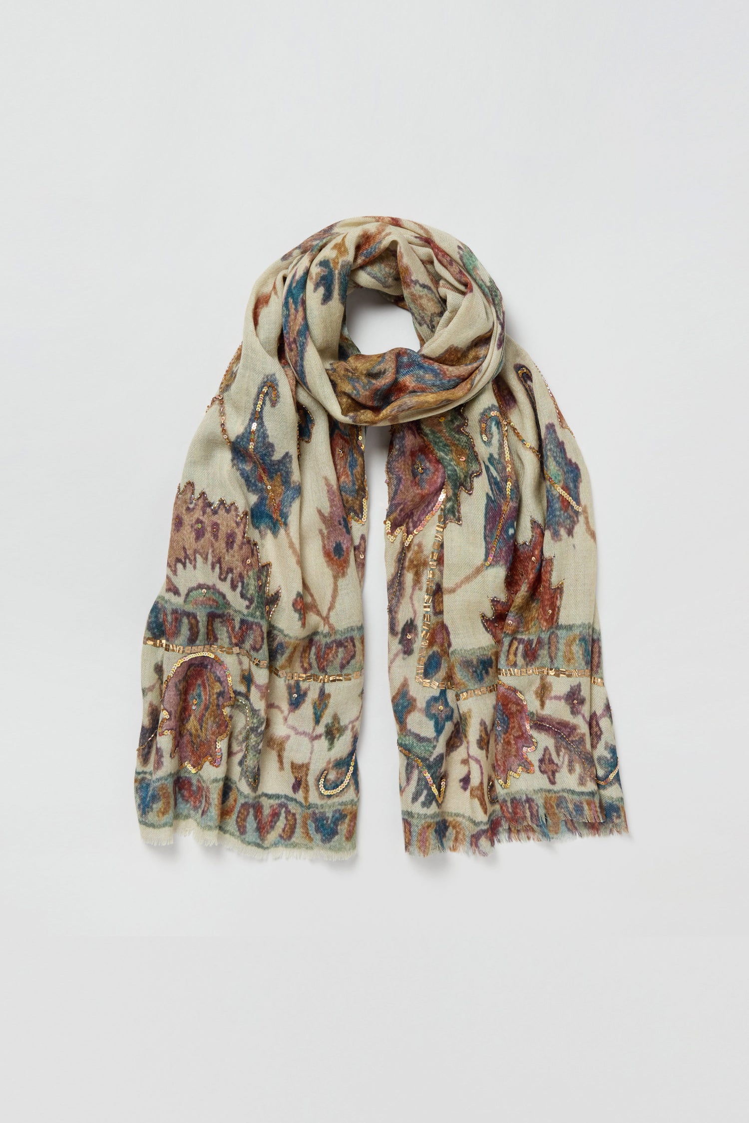The Embroidered Tapestry Wool Scarf, crafted in light beige wool and silk, showcases a vibrant paisley and floral pattern with fringed edges and a soft, lightweight feel, displayed flat on a white background.