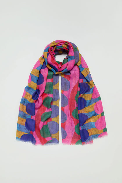 The Colour Pop Circles Wool Scarf, featuring bold oversized polka dots in pink, blue, mustard yellow, and green, is displayed on a plain white background.