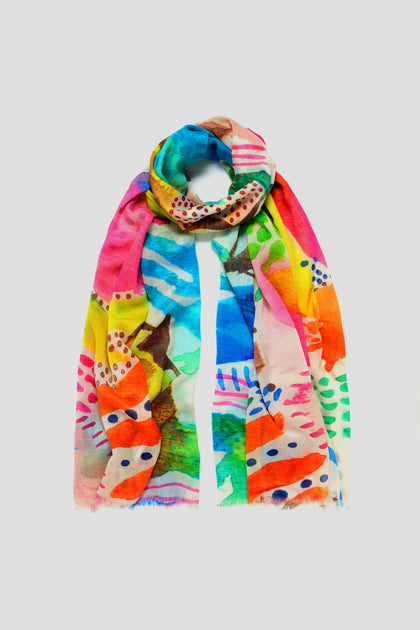 The Summit Cotton Modal Scarf offers vibrant style with abstract patterns in blue, pink, yellow, and green on a light gray background. Made from a soft cotton-modal blend, this lightweight and breathable scarf adds comfort and flair to any outfit.