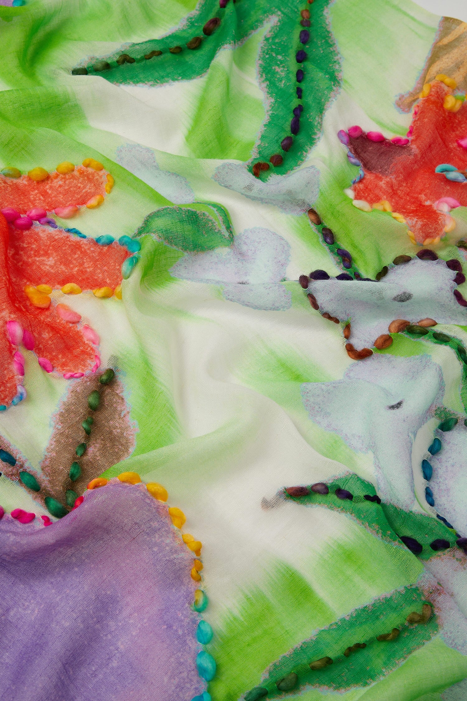 A Wild Garden Embroidered Scarf with an abstract floral pattern.