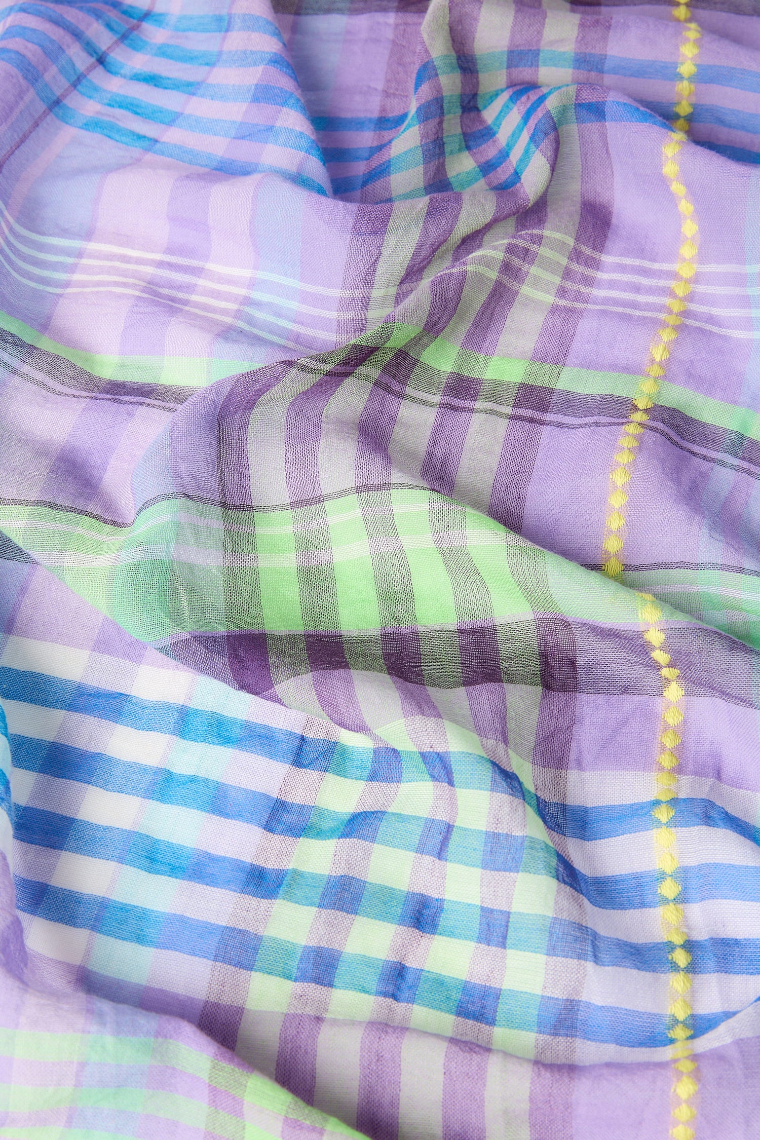 A close up of a purple and green Check Stitch Cotton Scarf, making it the perfect accessory.