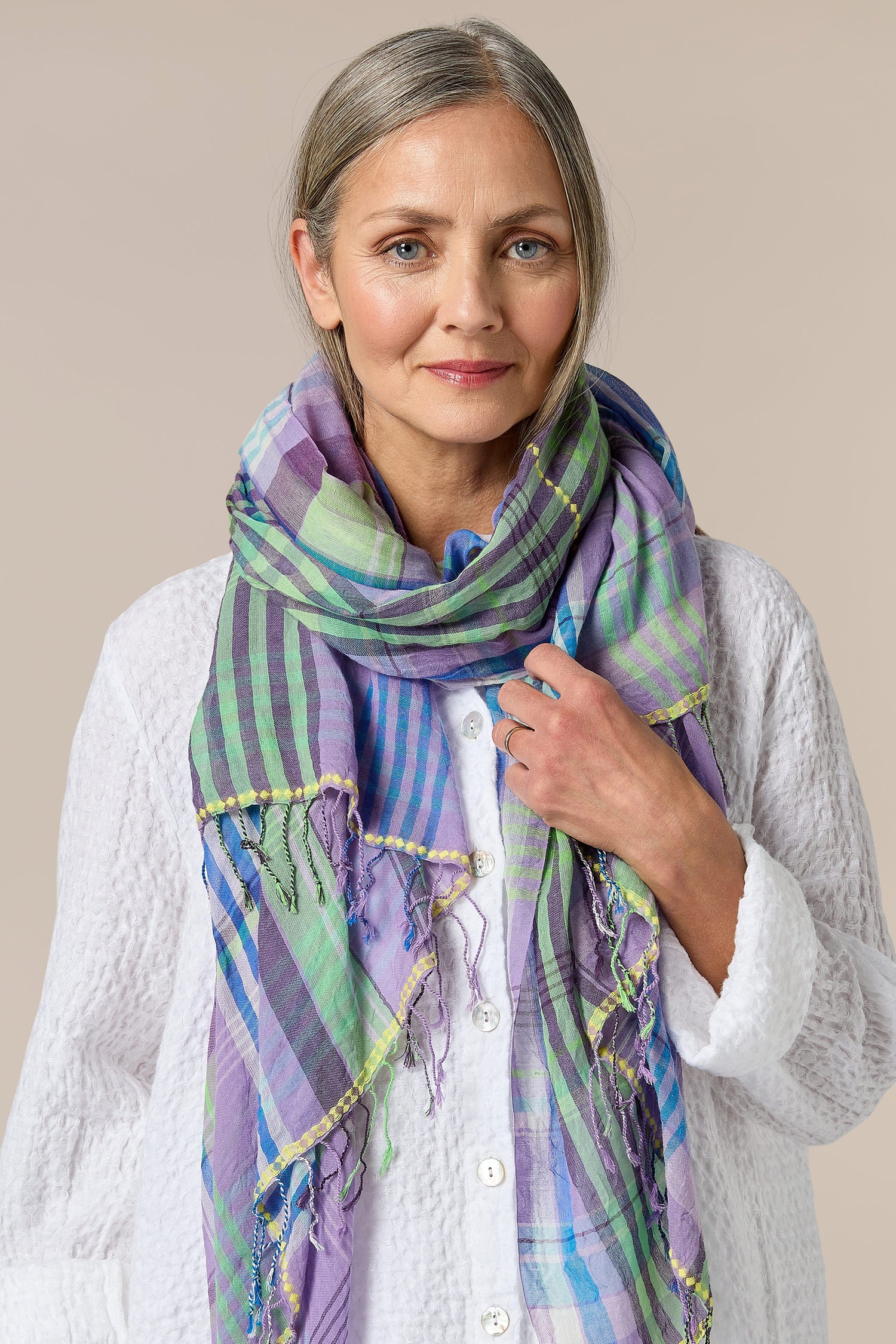 A woman wearing a Check Stitch Cotton Scarf.