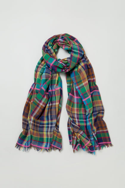 The Fuchsia Embroidered Check Scarf, a cotton blend with multicolored checks and fringed edges, features vibrant green, blue, yellow, and red tones—perfect for adding a lively accent to any outfit.
