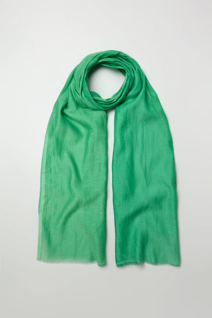 The Verdant Cotton Blend Scarf, in green and made from a soft cotton blend, is displayed flat against a simple, light background.