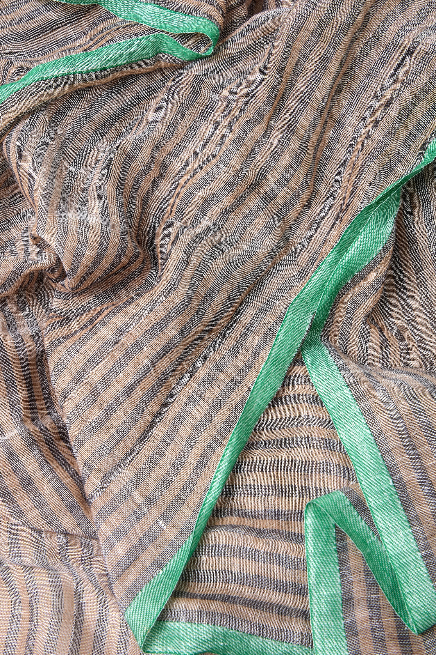 The Spearmint Trim Soft Stripe Scarf is a lightweight brown and beige accessory with shiny spearmint trim, shown draped in soft folds.