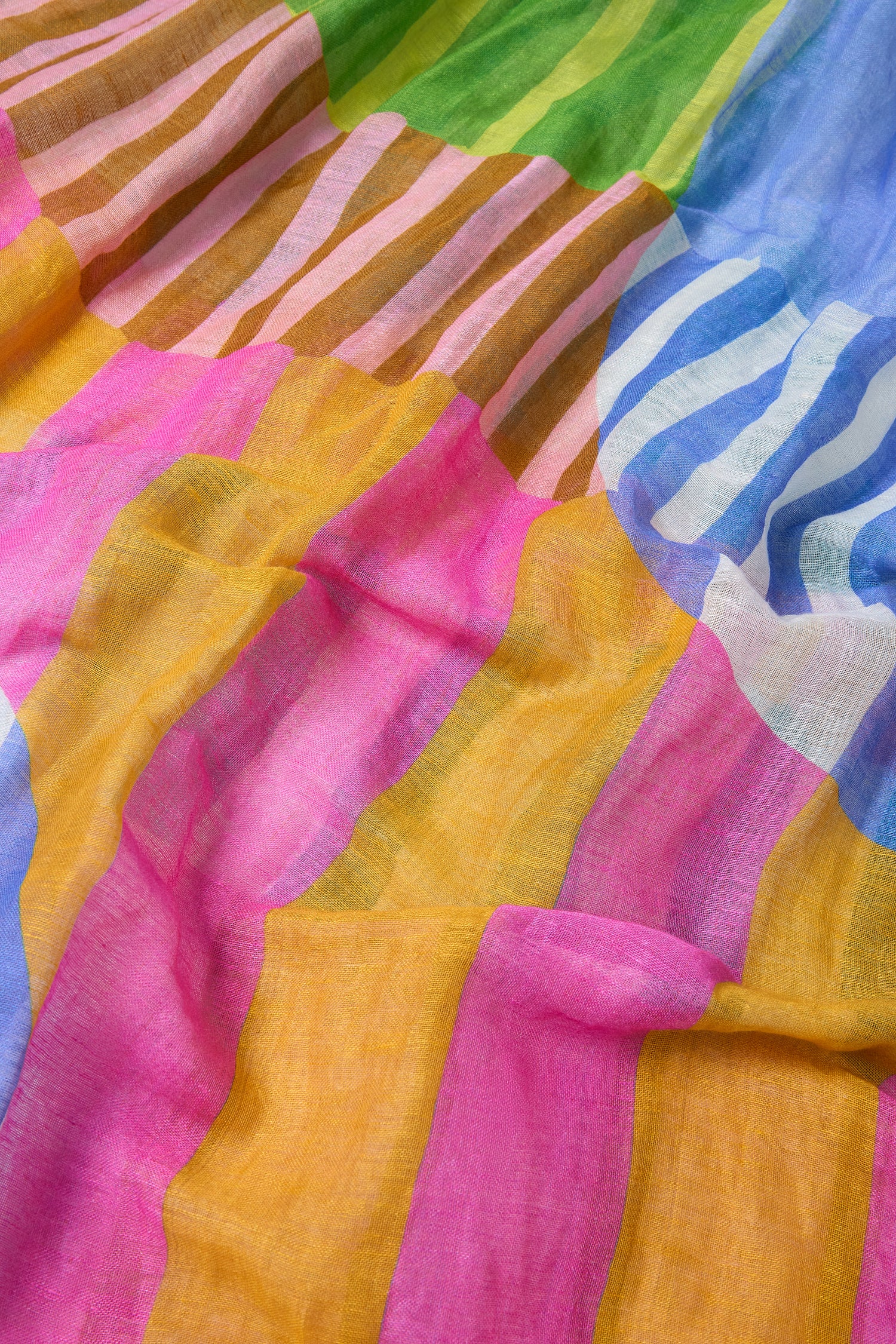 The Sunburst Block Print Linen Blend Scarf features overlapping stripes and circular patterns in pink, yellow, blue, green, and brown on a light, sheer fabric—ideal for a stylish lightweight scarf.