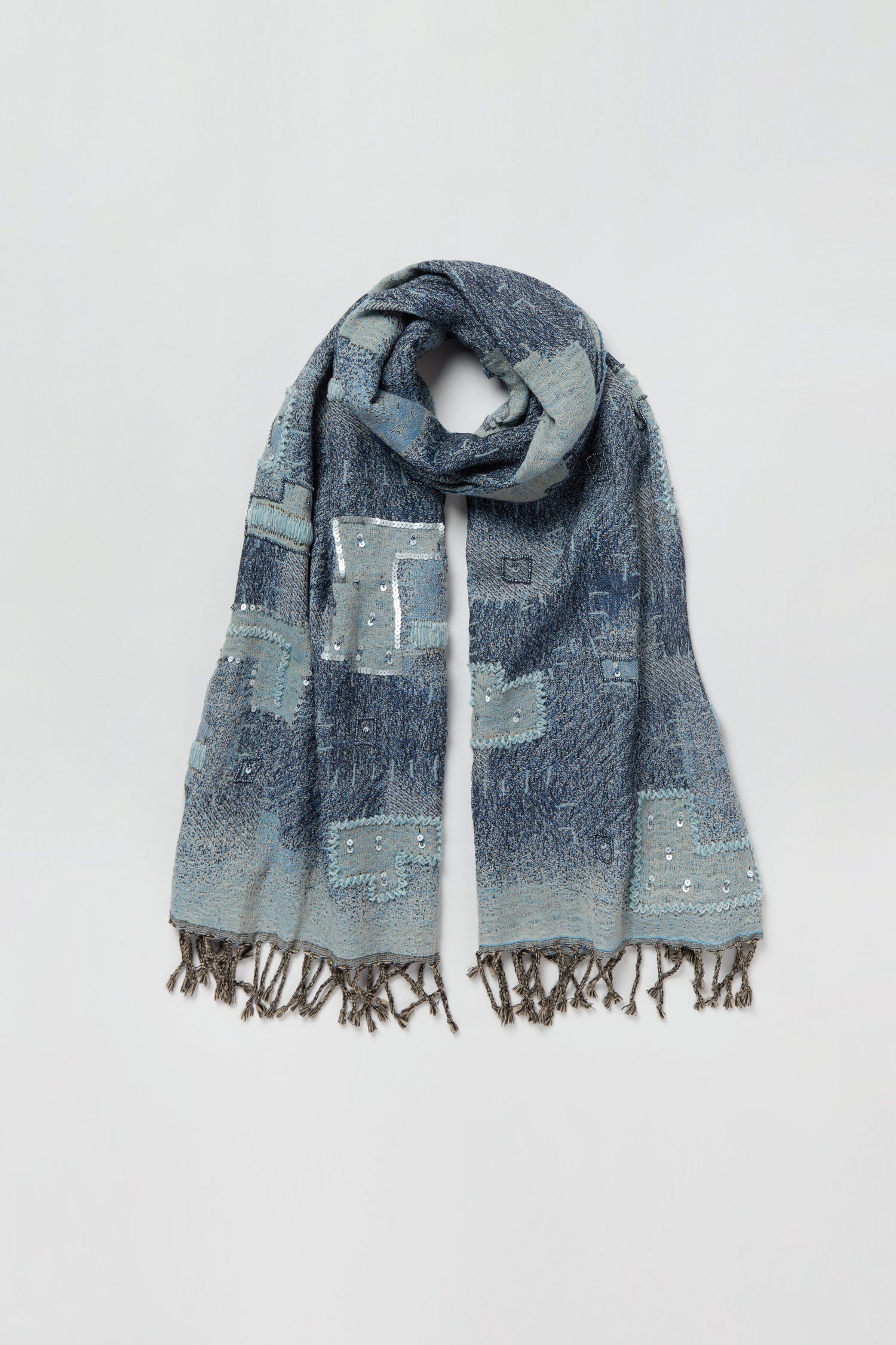 Etched Patchwork Sequin Wool Scarf in blue, showcasing a striking geometric patchwork design with subtle sequin accents and fringed ends, displayed against a plain white background.