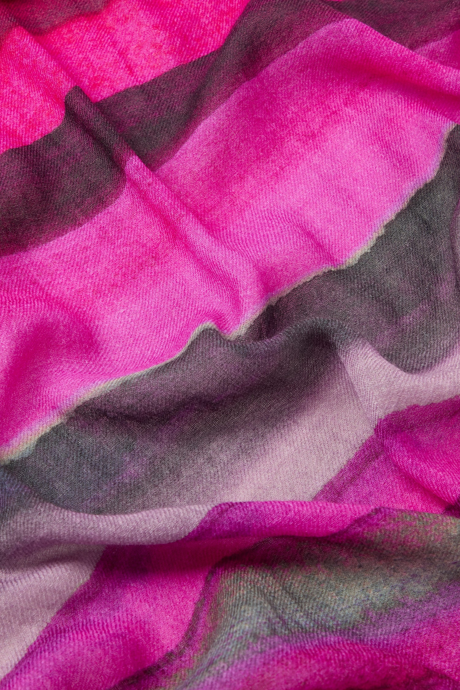 Close-up of the Crimson Twilight Stripe Scarf, showcasing a wavy pattern in sunset hues of pink, maroon, and gray, reminiscent of an autumn and winter fabric.