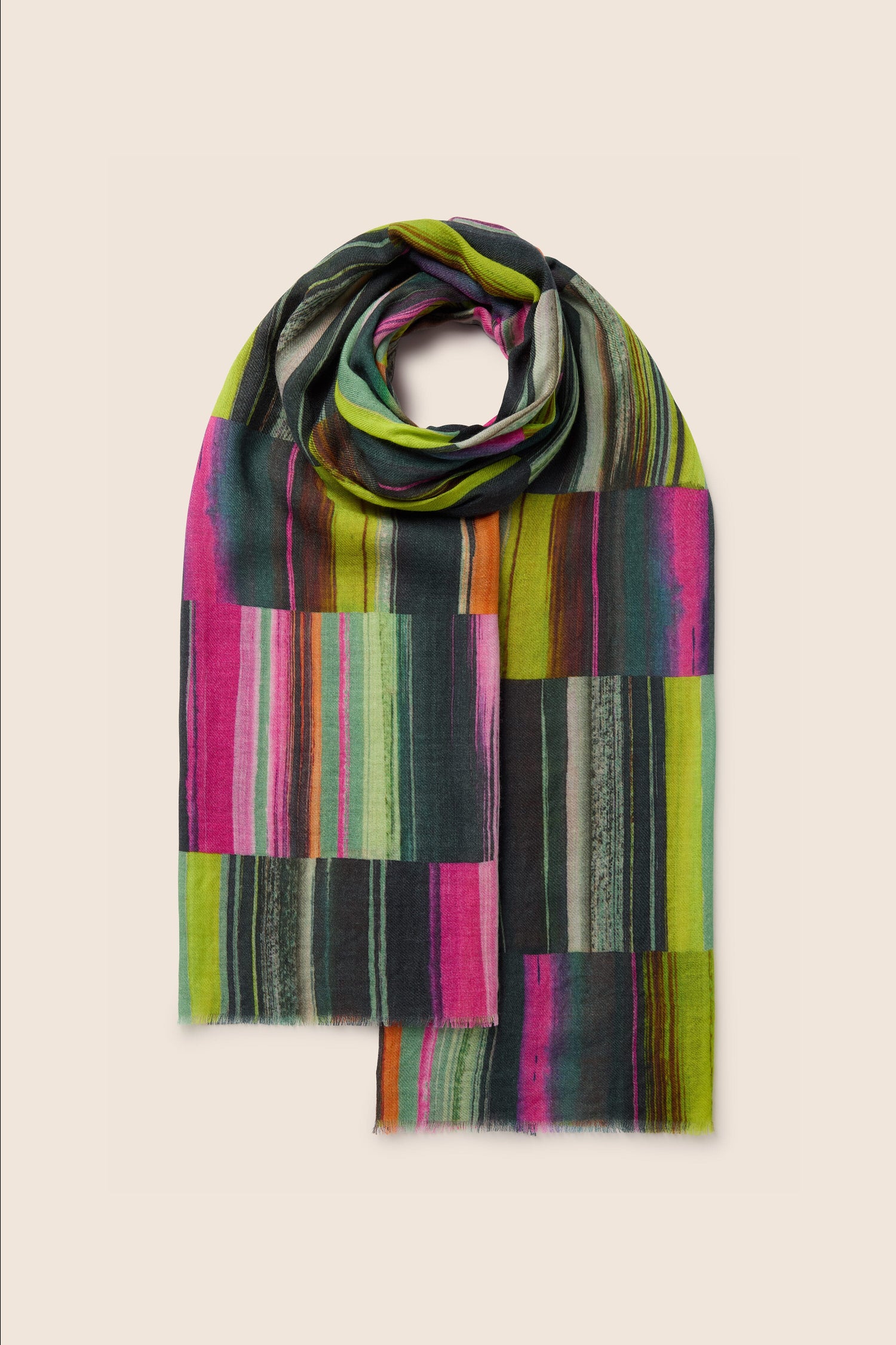 A Block Print Wool Mix Scarf featuring a vibrant mix of green, pink, orange, and black vertical and horizontal stripes, showcased against a plain background.