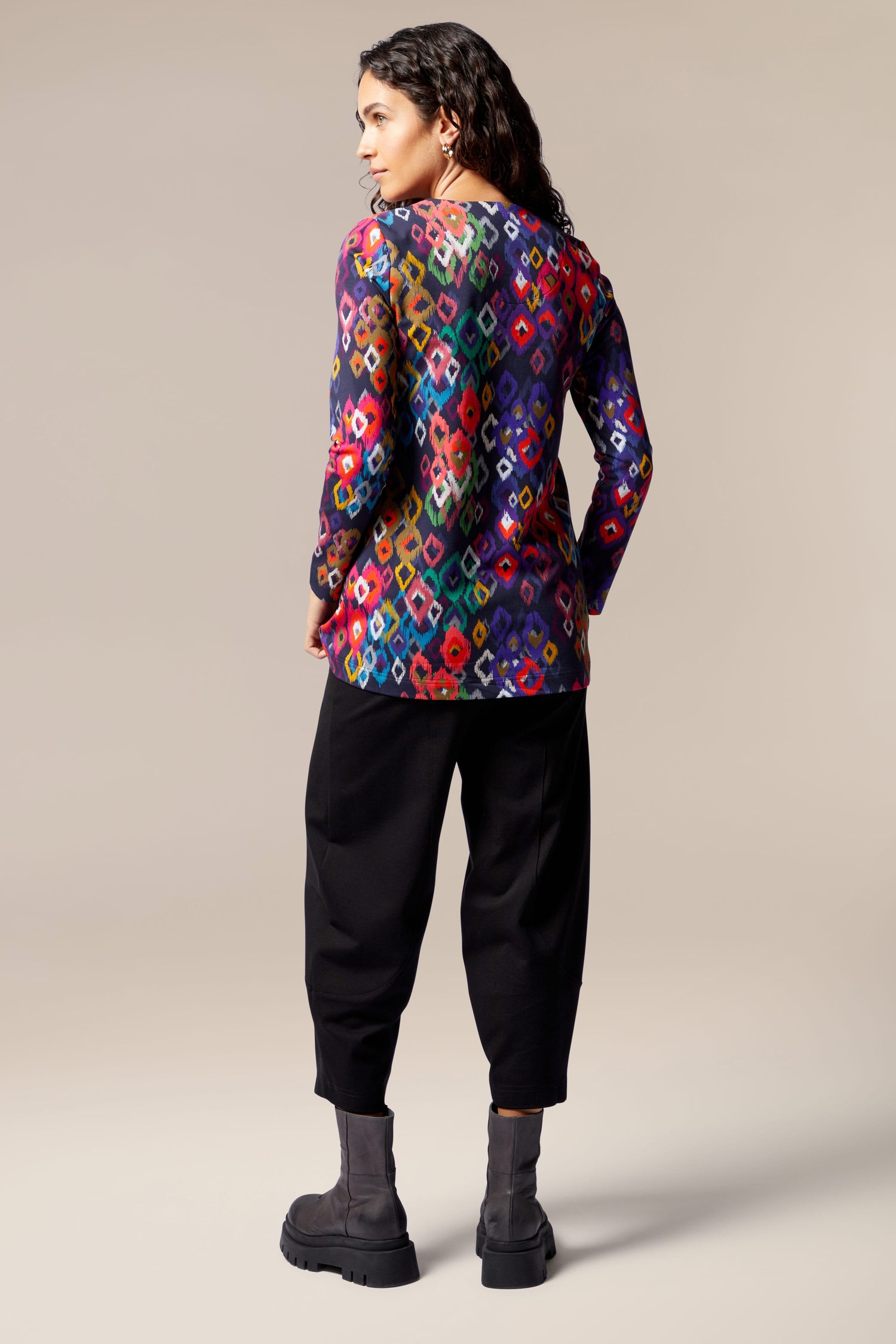 The back view of a woman wearing a Tanza Top, inspired by Nordic style.