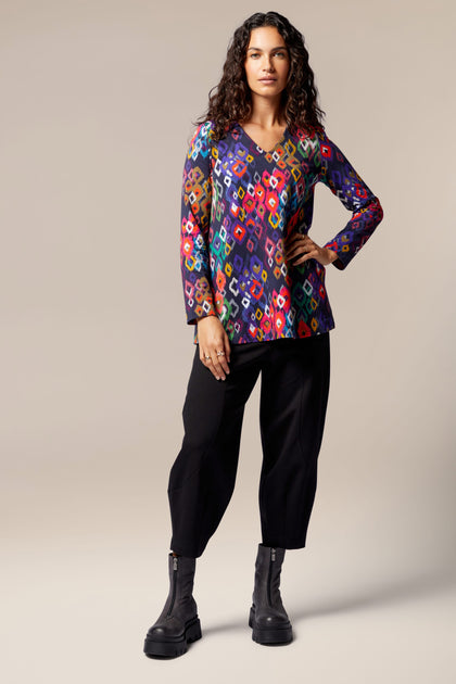 A woman wearing the Tanza Top, showcasing a contemporary Nordic style.
