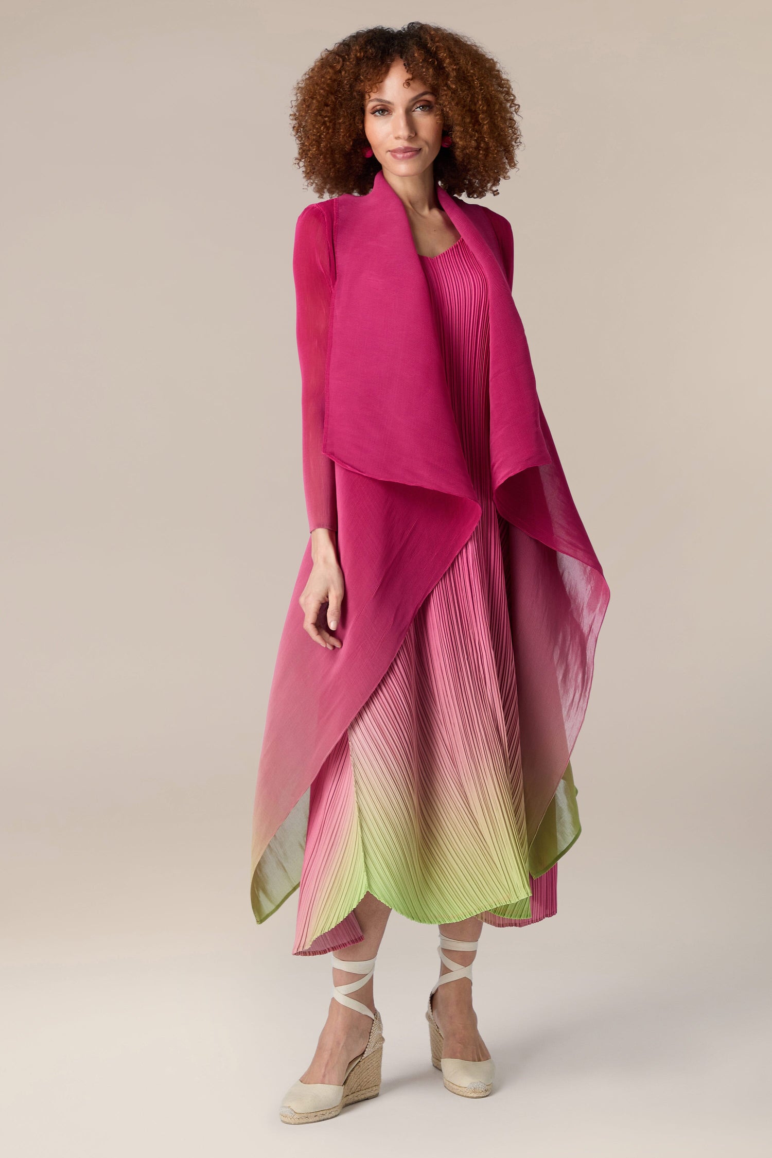 A woman wearing a pink Pleated Jacket.