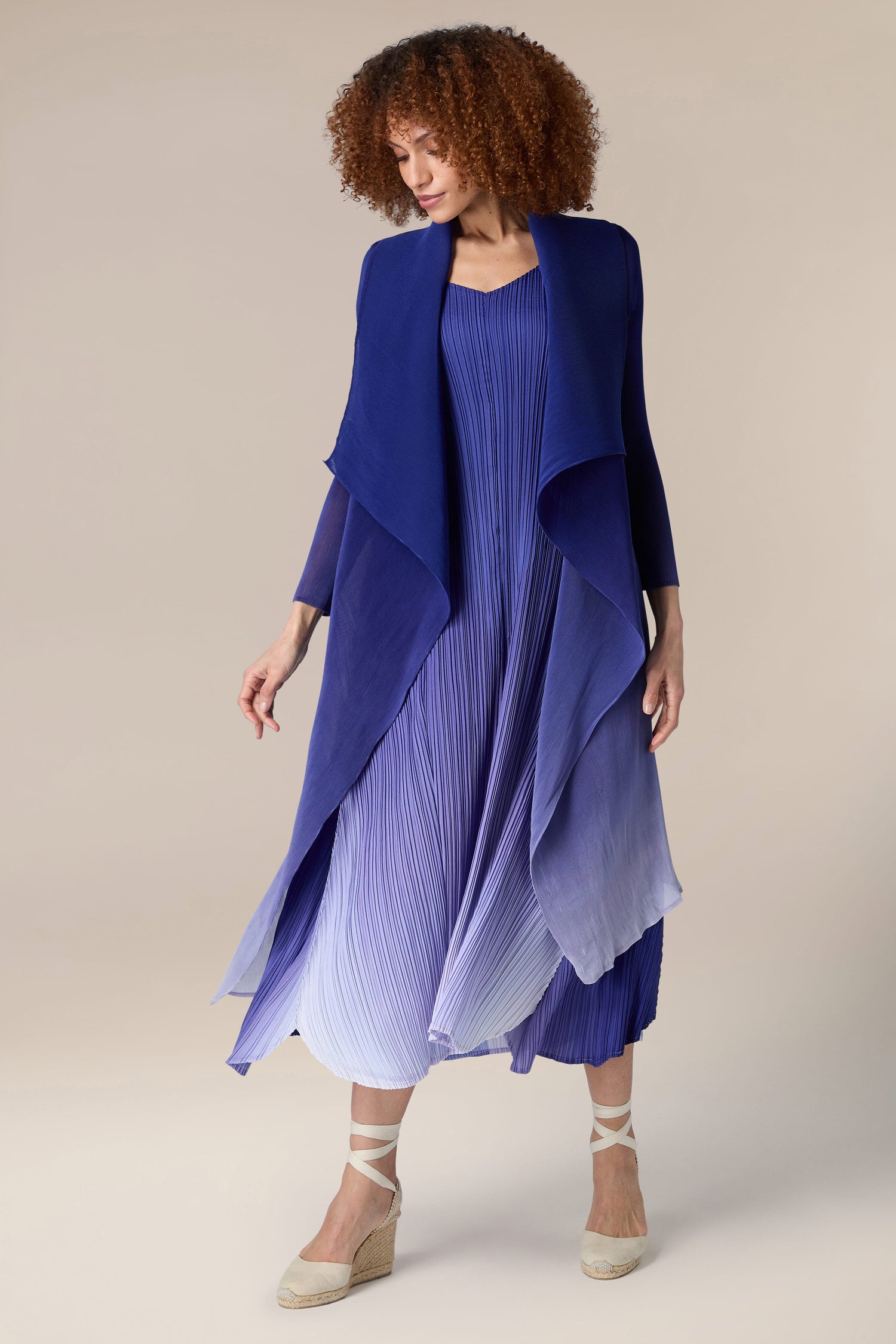 A woman wearing a pleated jacket.