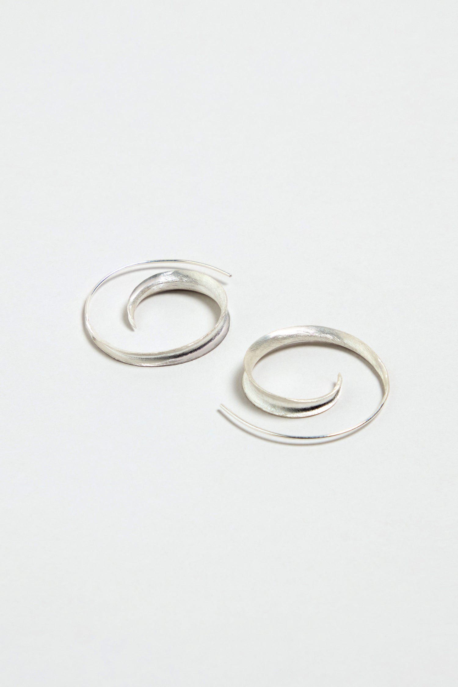 The Silver Swirl Earrings are displayed on a plain white background.
