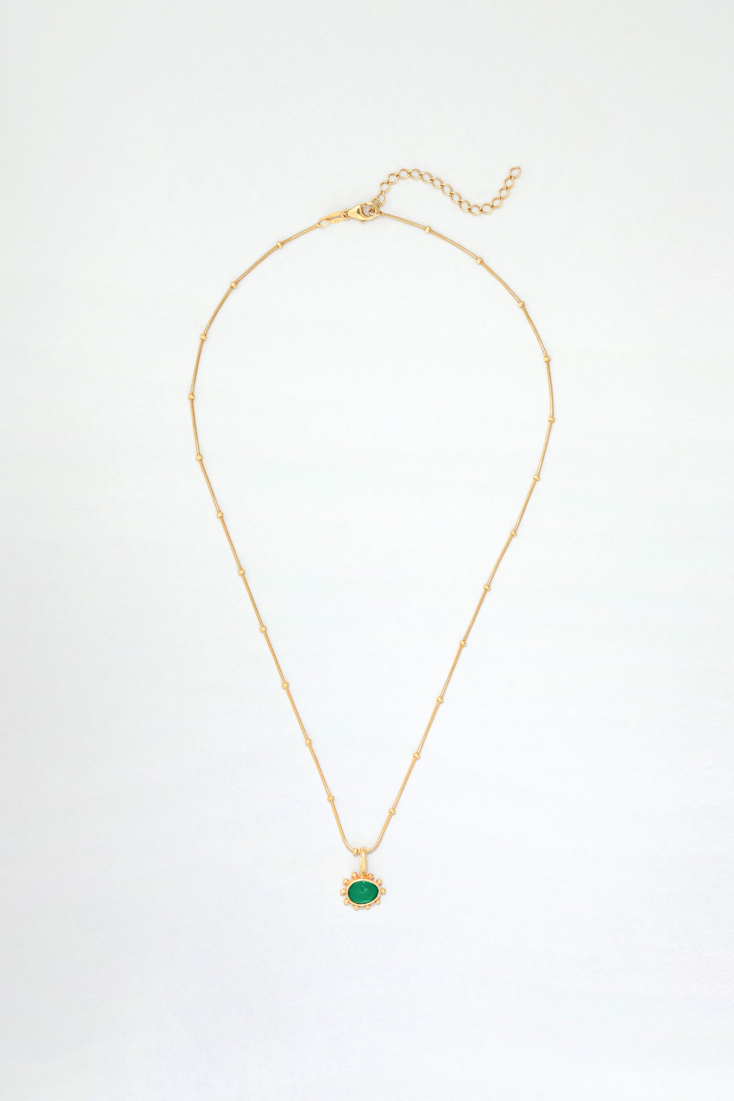 The Gold Vermeil Green Onyx Necklace features small beads, a faceted green onyx oval pendant, and a lobster clasp with adjustable extender.