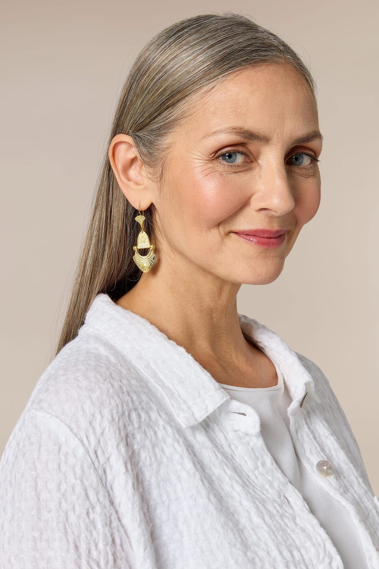 A woman wearing Engraved Gold Vermeil Tuareg Earrings.