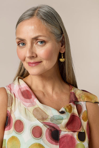 A woman wearing a Bohemian multi colored top and Gold Vermeil Mini Fan Earrings.