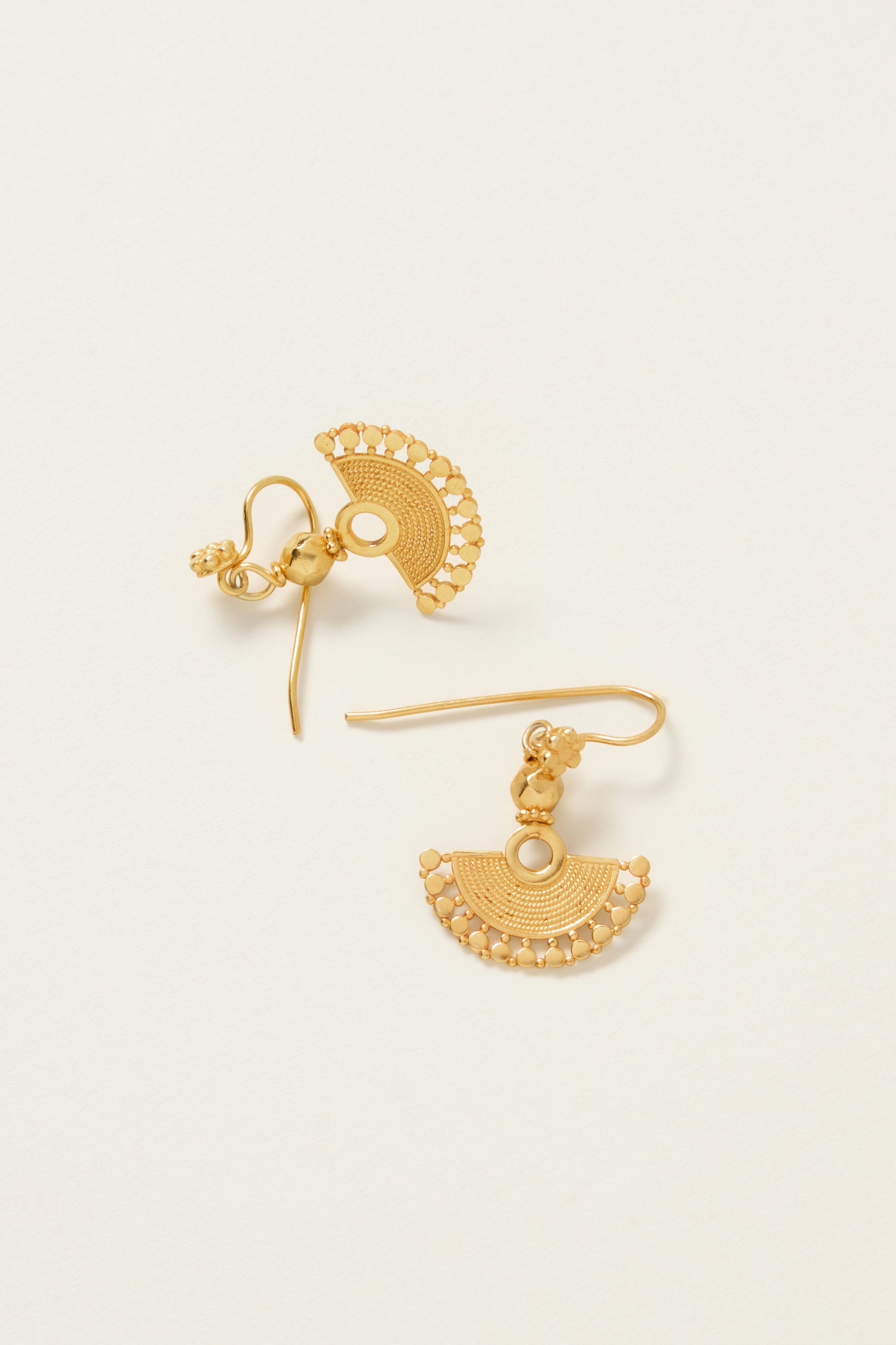 The 18ct Gold Vermeil Mini Fan Earrings showcase intricate circular patterns and small bead accents on a light background, embodying bohemian elegance with their luxurious 18ct gold vermeil finish.