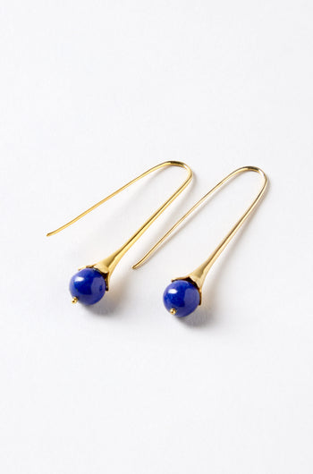 The Gold Vermeil Lapis Drop Earrings feature a gold hook and a round blue lapis bead, shown against a white background.
