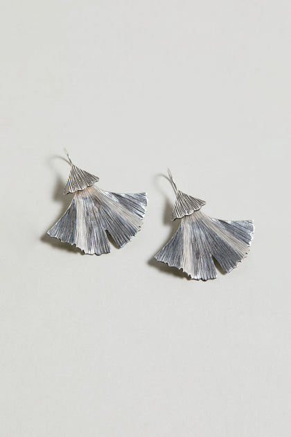 A pair of Silver Ginkgo Leaf Earrings in sterling silver with a textured design, set against a plain light background.