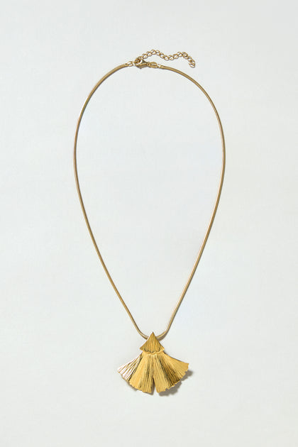 The Gold Vermeil Ginkgo Leaf Pendant features a delicate thin chain and a textured, fan-shaped pendant, displayed on a plain light background.