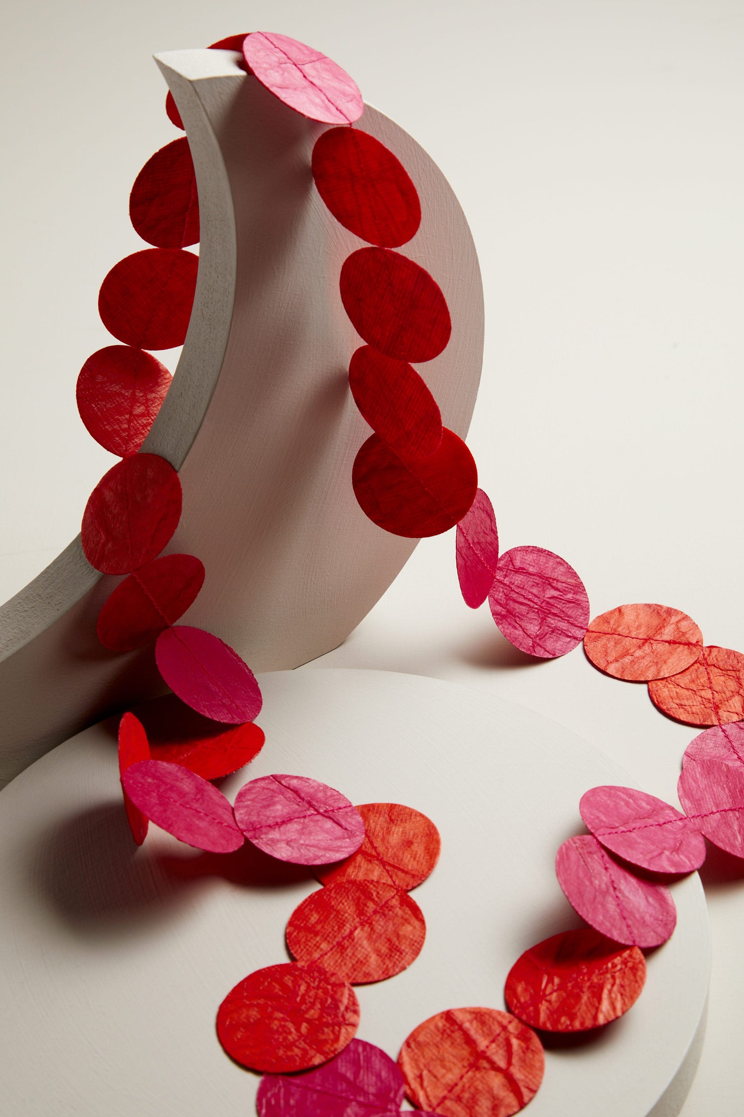 A roll of paper with red and pink circles, perfect for creating the Dotty Necklace.