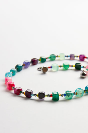 The Artisanal Rainbow Agate Cube Necklace by Arran Bay Jewellery features multicolored, irregular agate beads and a metal clasp, displayed on a white background.