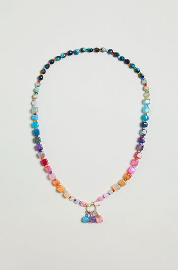 The Artisanal Rainbow Agate Toggle Necklace features multicolored agate beads in assorted shapes and sizes, accented with a cluster of vibrant charms at the center—handmade with care in Scotland.
