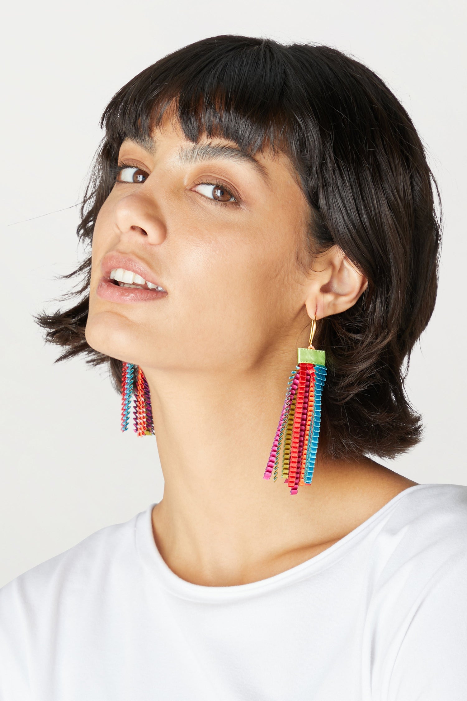 A woman wearing Pleated Earrings.