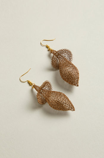A pair of Hand Crocheted Snowdrop Earrings featuring an elaborate floral design in gold-colored mesh, set against a simple light background.