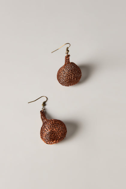 A pair of Hand Crocheted Teardrop Earrings in brown with a textured design and hook fastenings, highlighting artisanal craftsmanship, displayed on a plain light background.