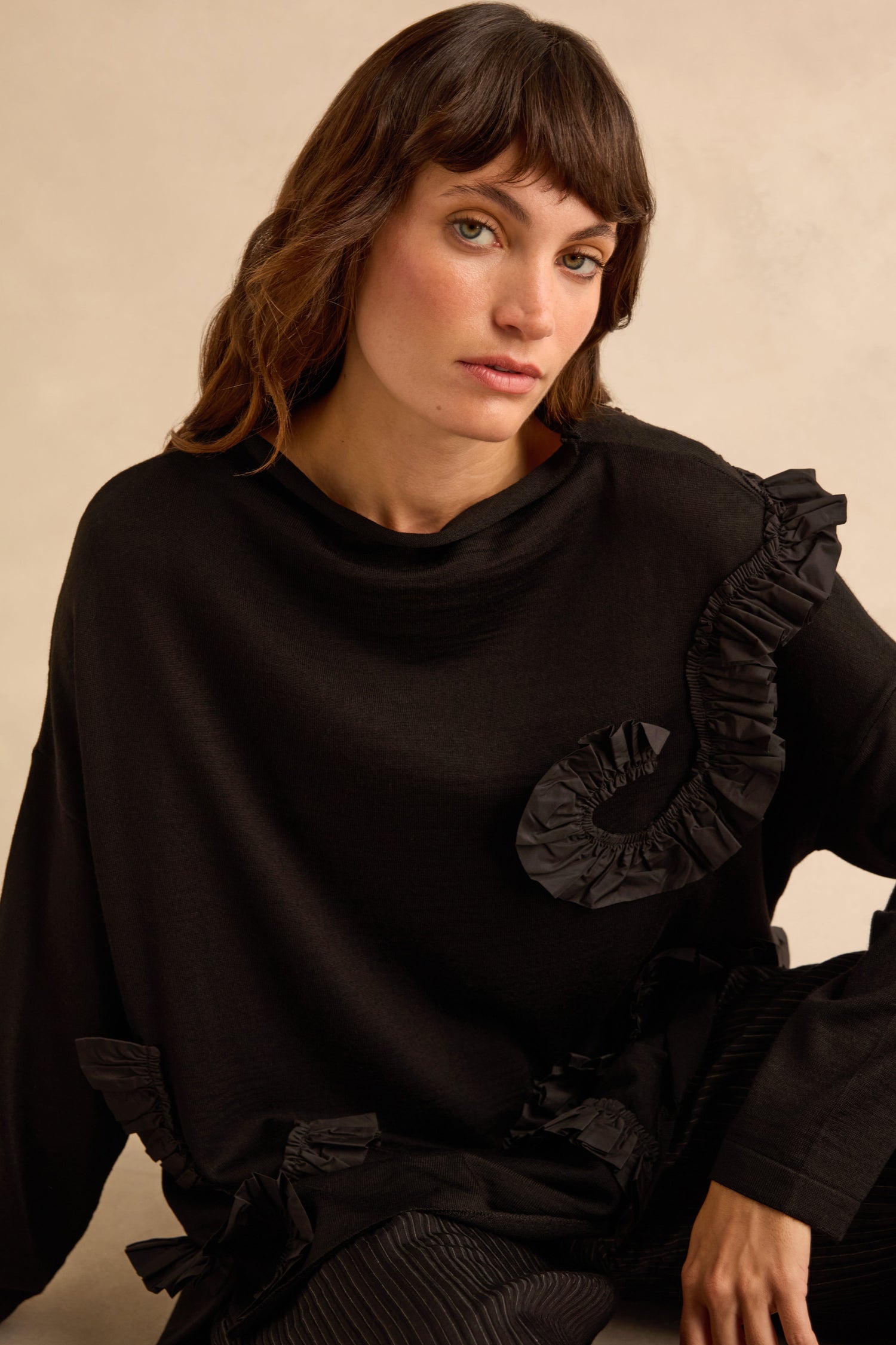 Taffeta Detail Knit Top: a black long-sleeve knit top in a relaxed shape with taffeta ruffle appliqué on the chest and side.