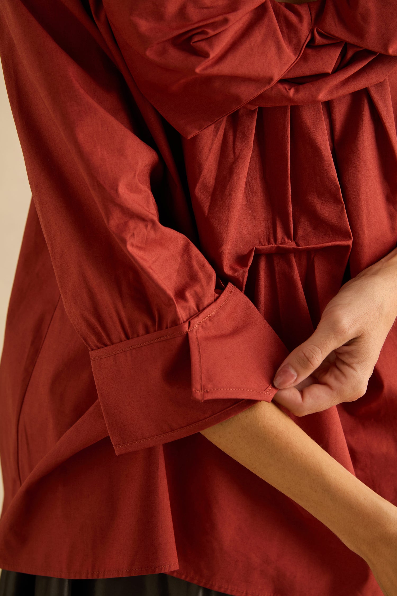 A person wearing a dark red Red Frill Neck Easy Top with a gathered neckline and three-quarter cuffed sleeves.