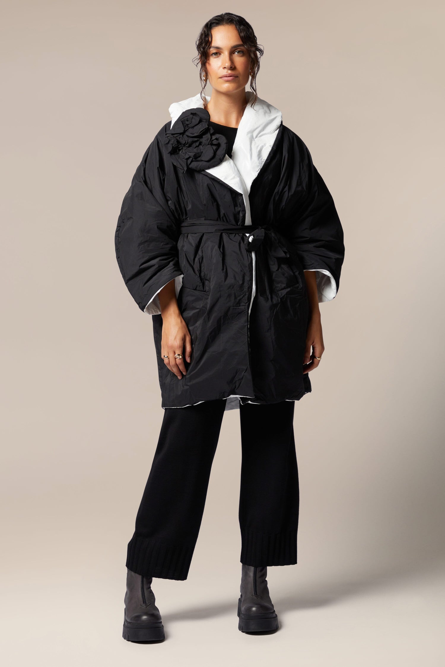 A woman wearing a black and white Reversible Puffa.