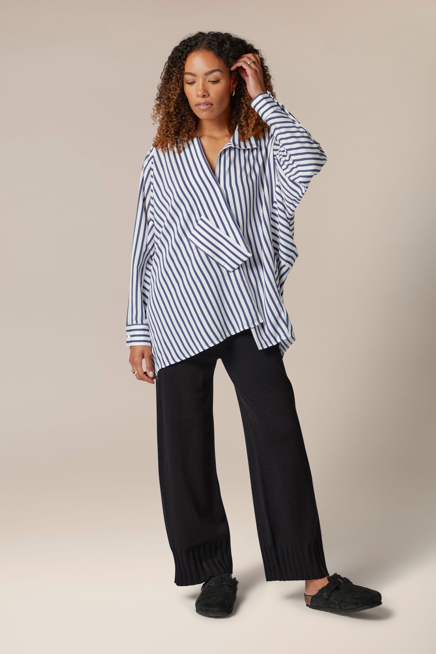 A woman wearing Rib Hem Knitted Trousers, a Turkish brand.