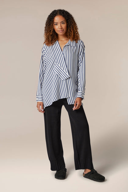 The model is wearing Rib Hem Knitted Trouser by a Turkish brand.