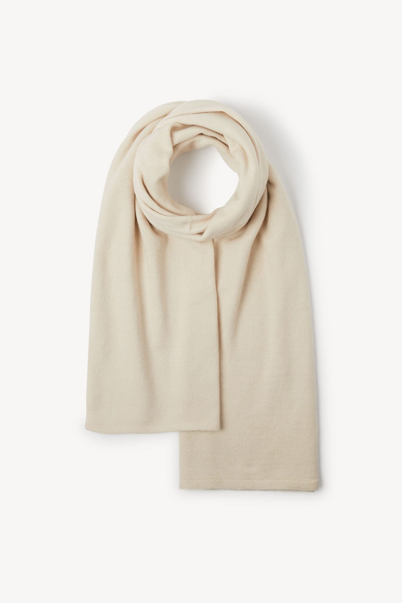 A cream-colored Knit Scarf, lightweight and luxurious, is neatly folded on a plain white background.