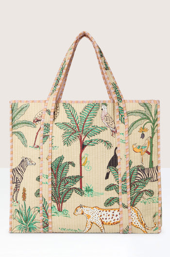 A large Jungle Print Tote Bag featuring a safari motif with various animals and green foliage, made from quilted fabric. It has two handles and a beige background adorned with colorful illustrations, perfect for members of the Conscious Yoga Collective.