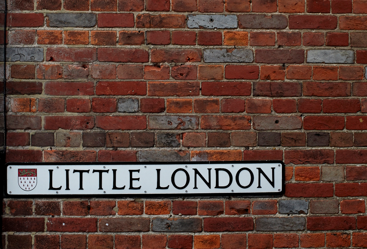 little london road sign on a brick wall